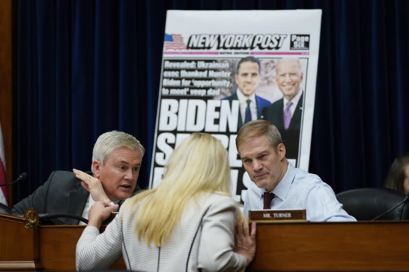 Rep. Marjorie Taylor Greene, R-Ga., center, talks with House Oversight and Accountability Committee Chairman James Comer, R-Ky., and House Judiciary Committee Chair Jim Jordan, R-Ohio, during a House Committee on Oversight and Accountability hearing titled "Protecting Speech from Government Interference and Social Media Bias, Part 1: Twitter's Role in Suppressing the Biden Laptop Story" on Capitol Hill, Wednesday, Feb. 8, 2023, in Washington. (AP Photo/Carolyn Kaster)