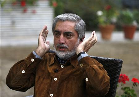 Afghan presidential candidate Abdullah Abdullah adjusts his headphones before an interview in Kabul April 24, 2014. REUTERS/Mohammad Ismail