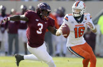 Virginia Tech defensive lineman Norell Pollard (3) chases Syracuse quarterback Garrett Shrader (16) during the second half of an NCAA college football game in Blacksburg Va., Saturday, Oct. 23 2021. (Matt Gentry/The Roanoke Times via AP)