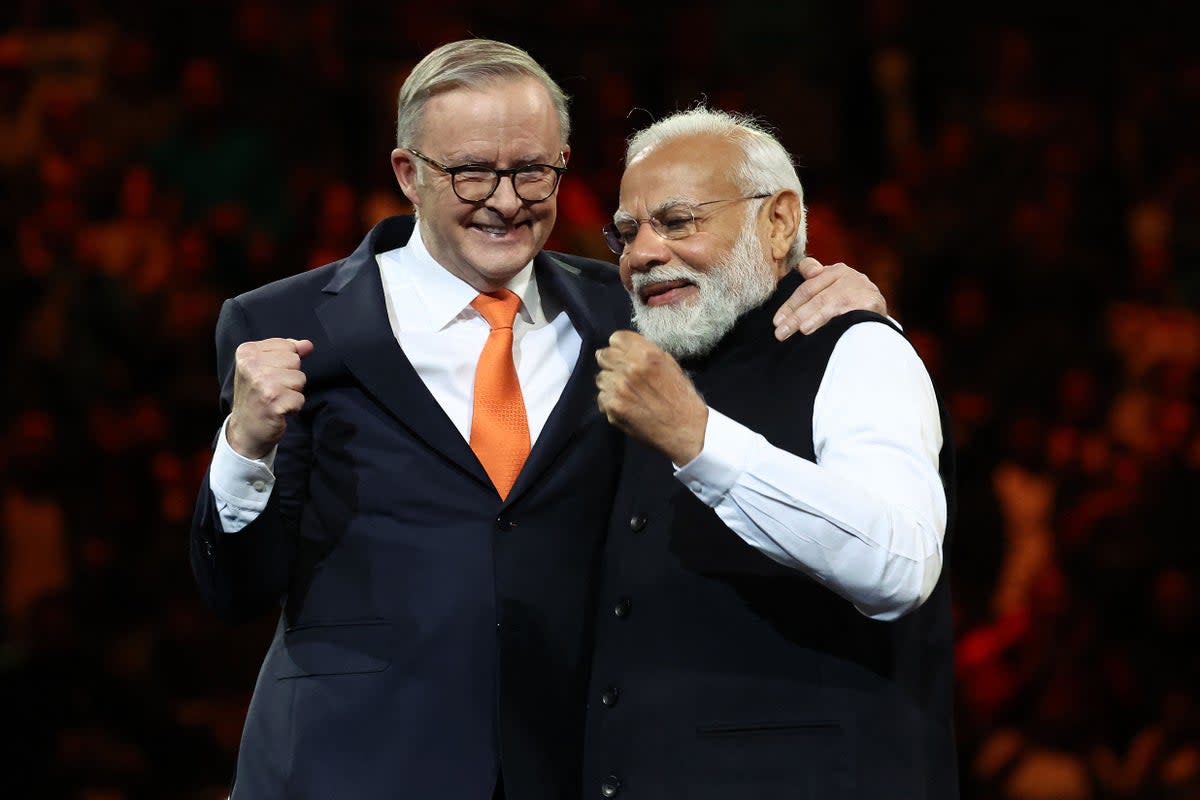 India’s prime minister Narendra Modi and Australia’s prime minister Anthony Albanese gesture during an event with members of the local Indian community at the Qudos Arena in Sydney (AFP via Getty Images)