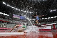 <p>Morocco's Mohamed Tindouft falls next to Italy's Ala Zoghlami while competing in the men's 3000m steeplechase heats during the Tokyo 2020 Olympic Games at the Olympic Stadium in Tokyo on July 30, 2021. (Photo by Andrej ISAKOVIC / AFP)</p> 