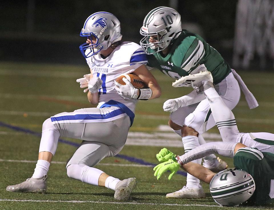 Danvers running back Max Gasinowski breaks a tackle by Duxbury #10 Brendan Bonner.Duxbury hosted Danvers football in MIAA playoff action on Friday November 12, 2021 