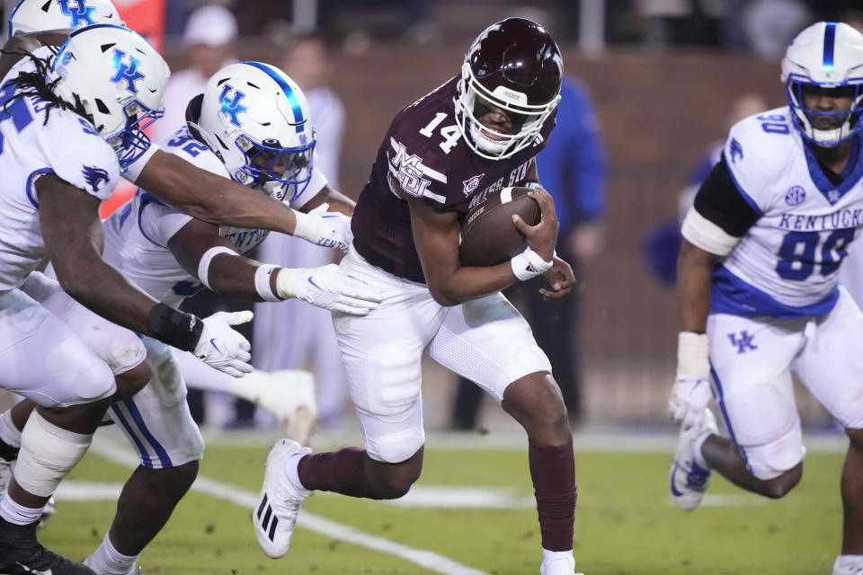 Mississippi State quarterback Mike Wright (14) is pursued by Kentucky defenders during the second half of an NCAA college football game in Starkville, Miss., Saturday, Nov. 4, 2023. (AP Photo/Rogelio V. Solis)