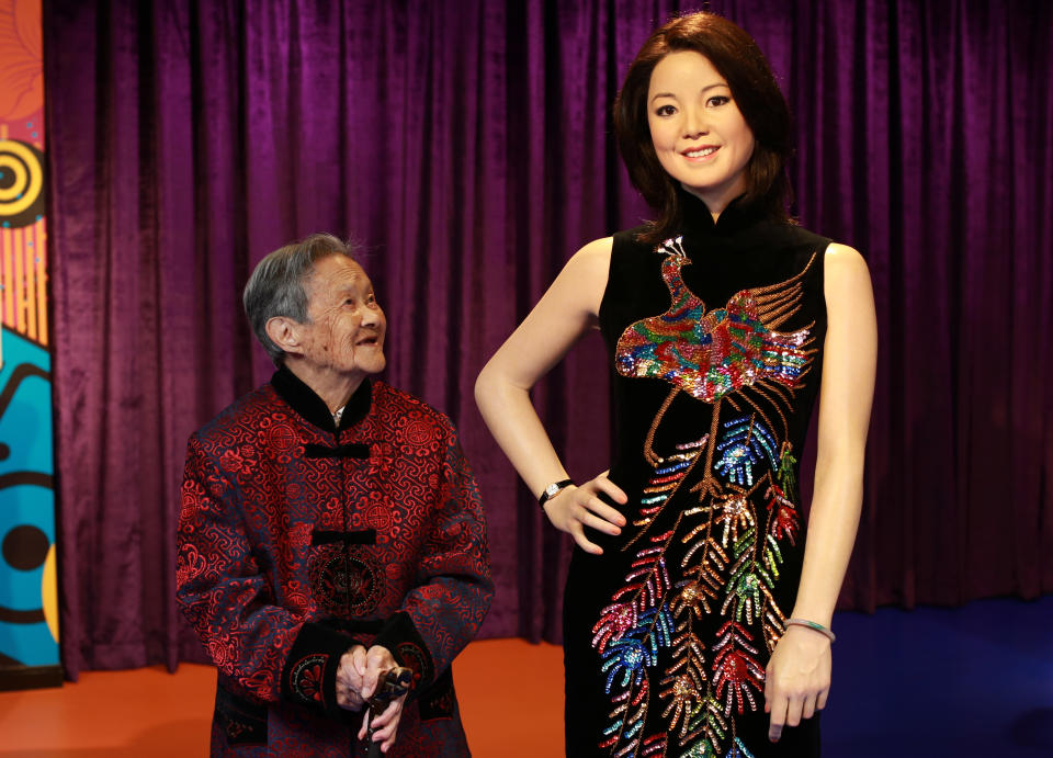 uang Xiaogui, 100 years old, poses with a wax figure of Teresa Teng at Madame Tussauds on in Wuhan, China on Oct. 11, 2013.