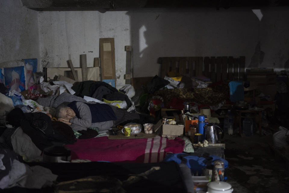 A woman lies on a bed inside a basement used as a bomb shelter during Russian attacks in Severodonetsk, Luhansk region, Ukraine, Friday, May 13, 2022. (AP Photo/Leo Correa)