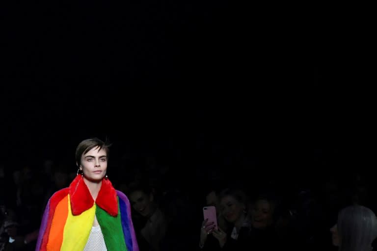 British model Cara Delevingne sported a gorgeous rainbow faux fur cape