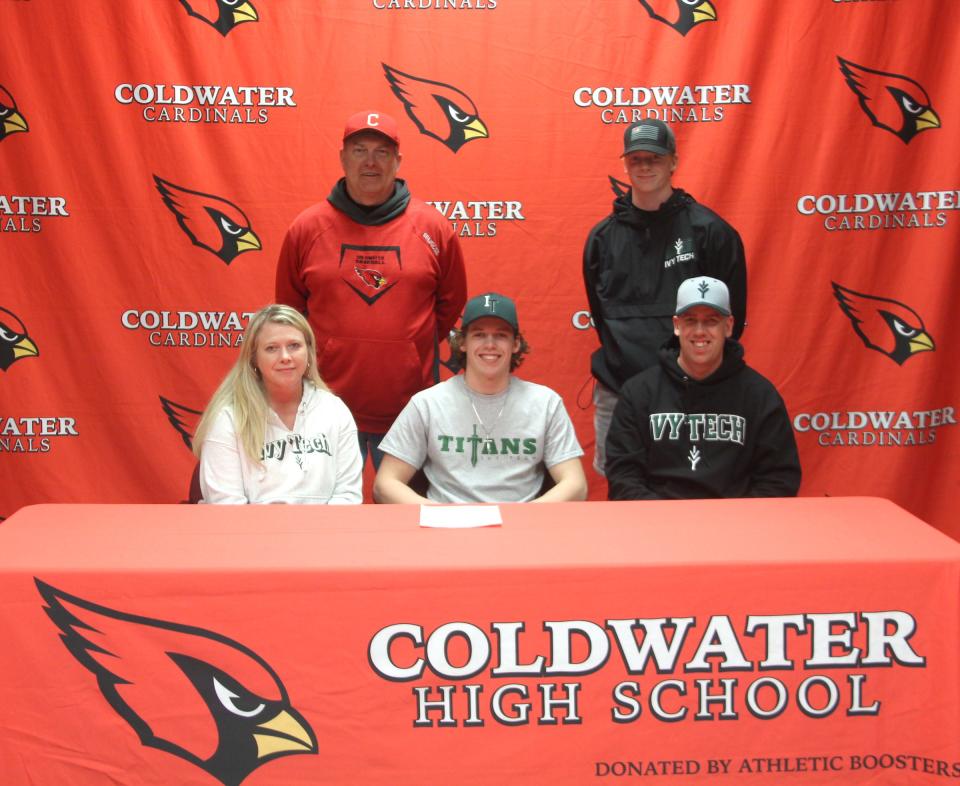 Coldwater's Brock Thornton (center) signs his letter of intent, surrounded by family, friends and coaches, to play baseball at Ivy Tech Community College.