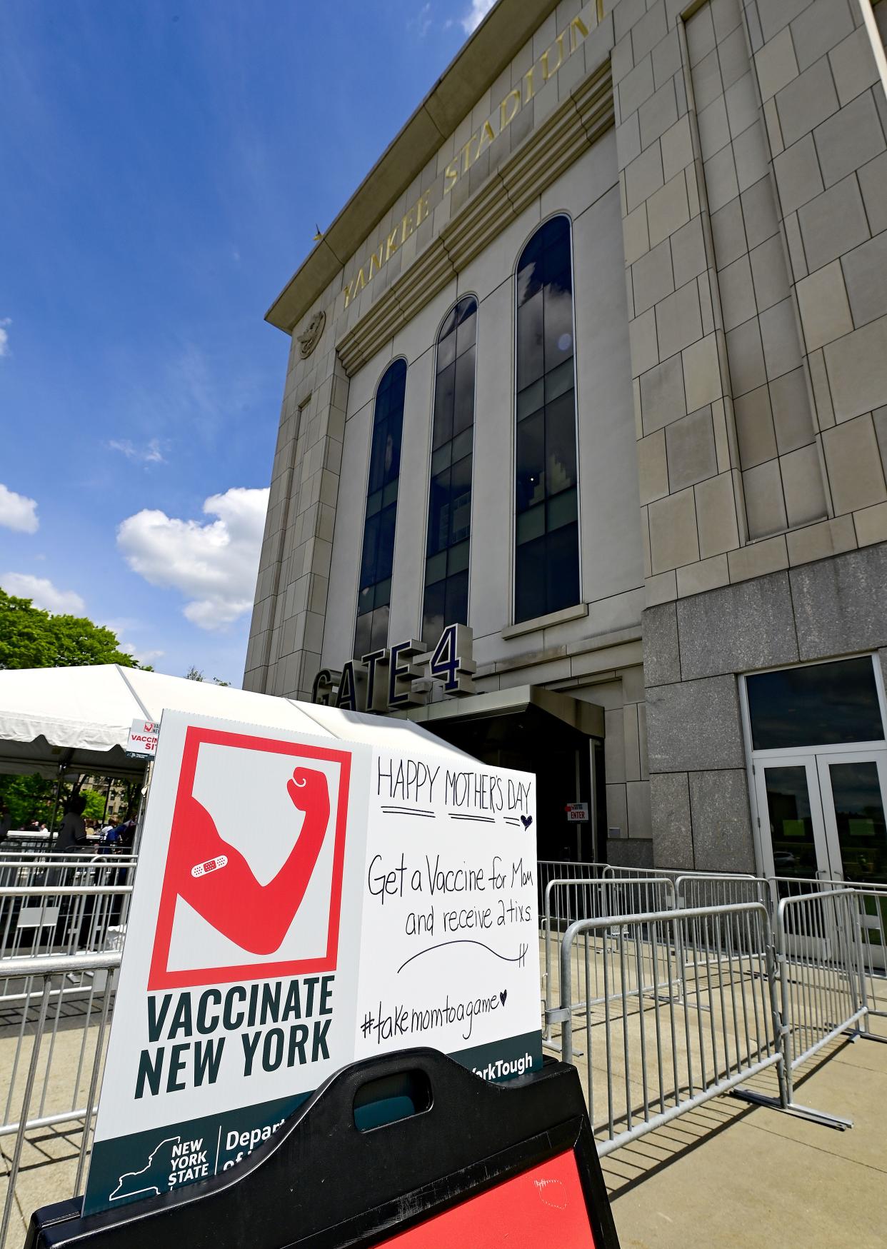 A sign offers fans free tickets to a future game if they get a COVID-19 vaccine offered at the stadium prior to the game between the New York Yankees and the Washington Nationals at Yankee Stadium on May 9, 2021, in the Bronx borough of New York City. New York Governor Andrew Cuomo announced this COVID vaccine initiative on May 5.