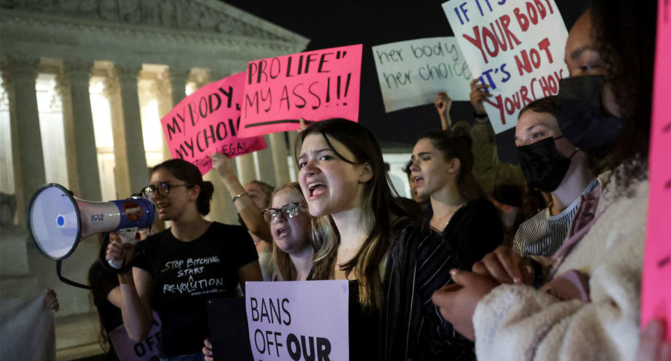 People are protesting with placards and chanting outside the Supreme Court. Source: Getty