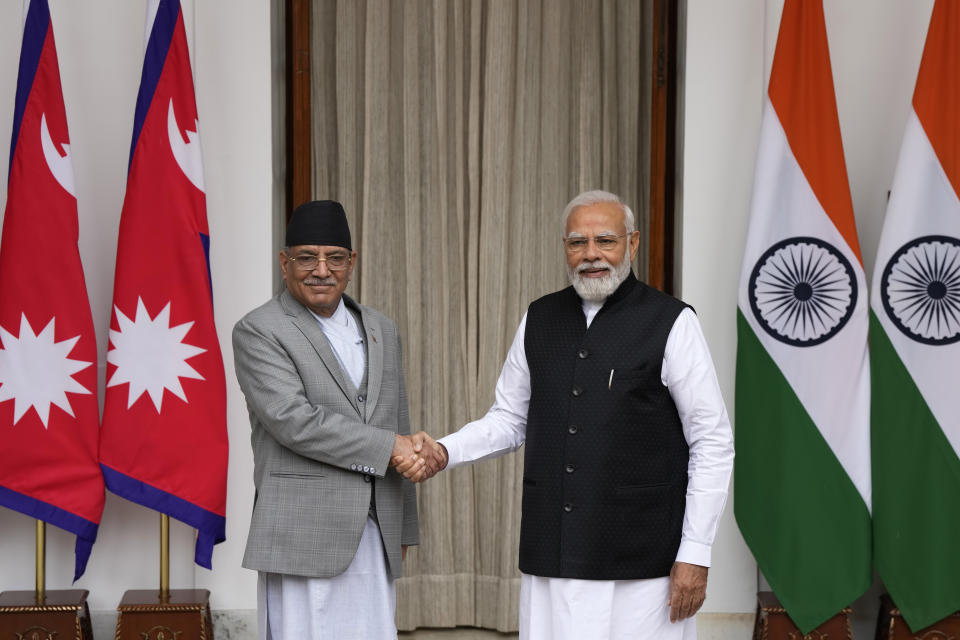 Nepal’s Prime Minister Pushpa Kamal Dahal and his Indian counterpart Narendra Modi, right, pose for the media before their meeting in New Delhi, India, Thursday, June 1, 2023. Dahal arrived Wednesday on a state visit, his first trip abroad since taking power in December last year. (AP Photo/Manish Swarup)