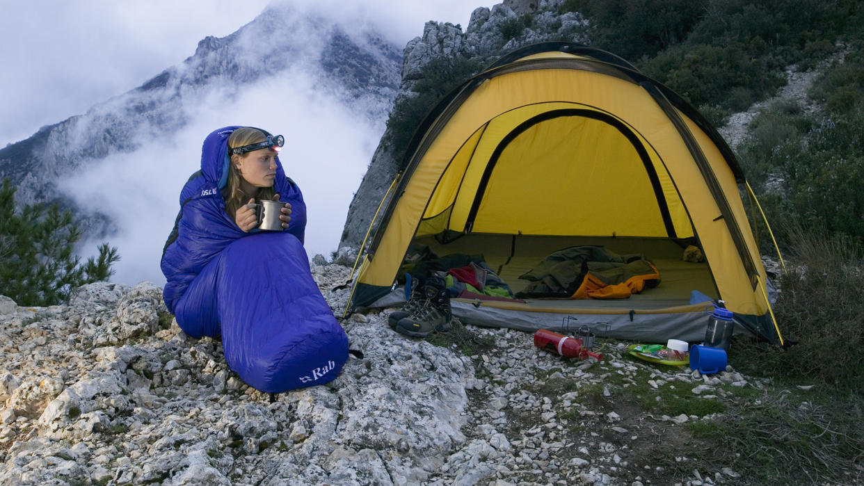  Woman in Sleeping Bag Next to Tent. 