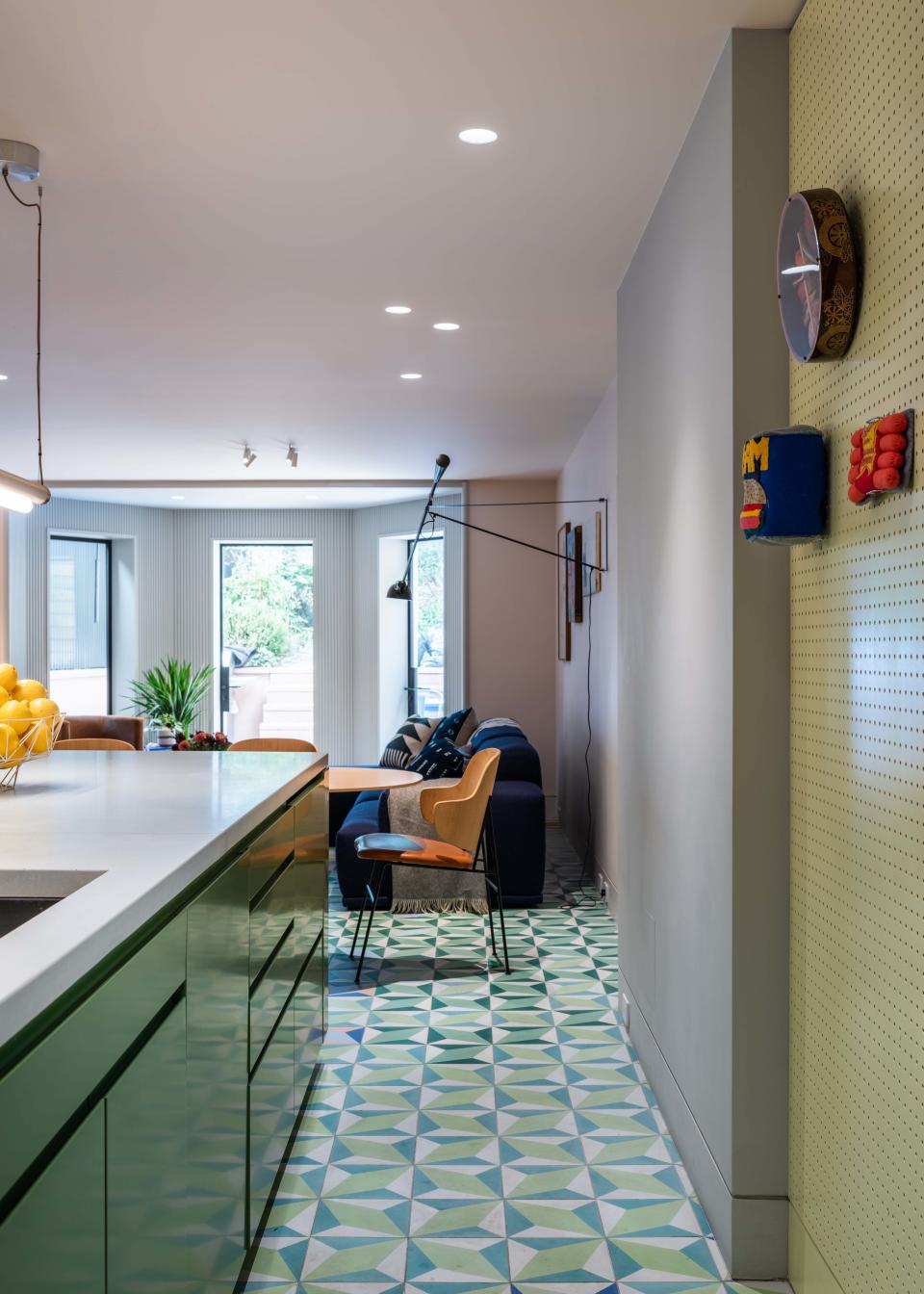 A peek through the kitchen to the adjoining lounge space, leading out to the patio. “The homeowners have a newborn and a dog, so the ability to easily move between spaces was important to them,” notes Michael.