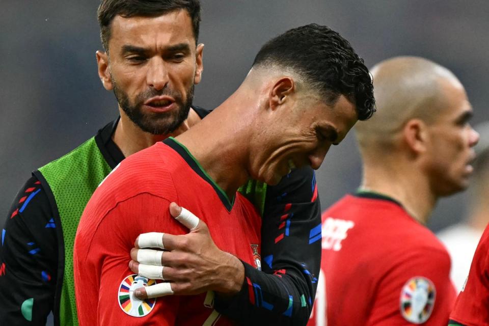 Ronaldo had to be consoled by teammates after missing a penalty in extra-time (AFP via Getty Images)