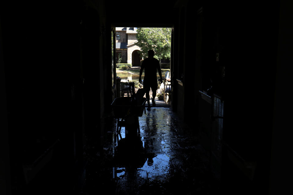 Homeowner Maurice Teixeira stands in the entrance way to his family home as he begins cleanup after floodwaters receded in the aftermath of Harvey.