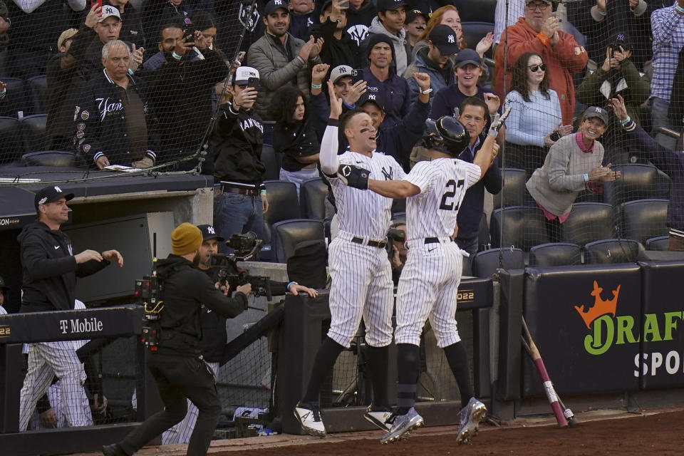 New York Yankees Giancarlo Stanton (27) celebrates with Aaron Judge after hitting a three-run home run against the Cleveland Guardians during the first inning of Game 5 of an American League Division baseball series, Tuesday, Oct. 18, 2022, in New York. (AP Photo/Seth Wenig)