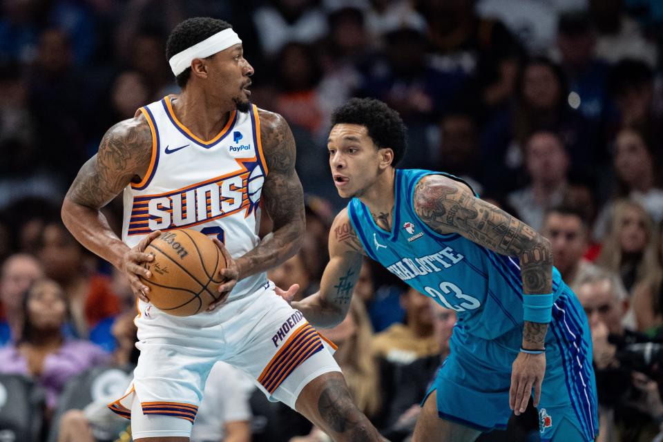 Tre Mann #23 of the Charlotte Hornets guards Bradley Beal #3 of the Phoenix Suns in the second quarter during their game at Spectrum Center on March 15, 2024, in Charlotte.