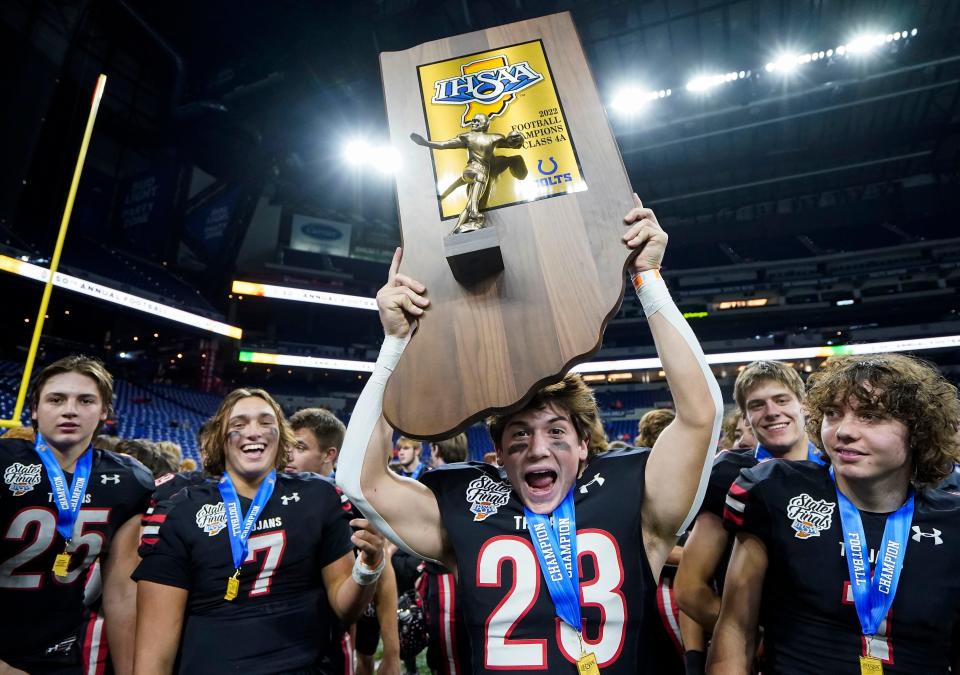 East Central Trojans Peyton Pemberton (23) holds up the the trophy during the IHSAA Class 4A state championships Friday, Nov 25, 2022 at Lucas Oil Stadium in Indianapolis. East Central Trojans defeated the New Prairie Cougars, 37-7. 