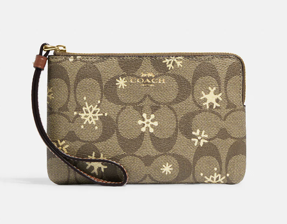 Corner Zip Wristlet in Signature Canvas With Snowflake Print Khaki/Gold Multi (Photo via Coach Outlet)