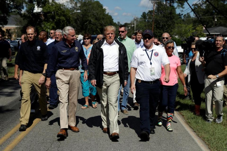 Mr Trump went on a two-state visit to the Carolinas on Wednesday in aftermath of Hurricane Florence (AP)