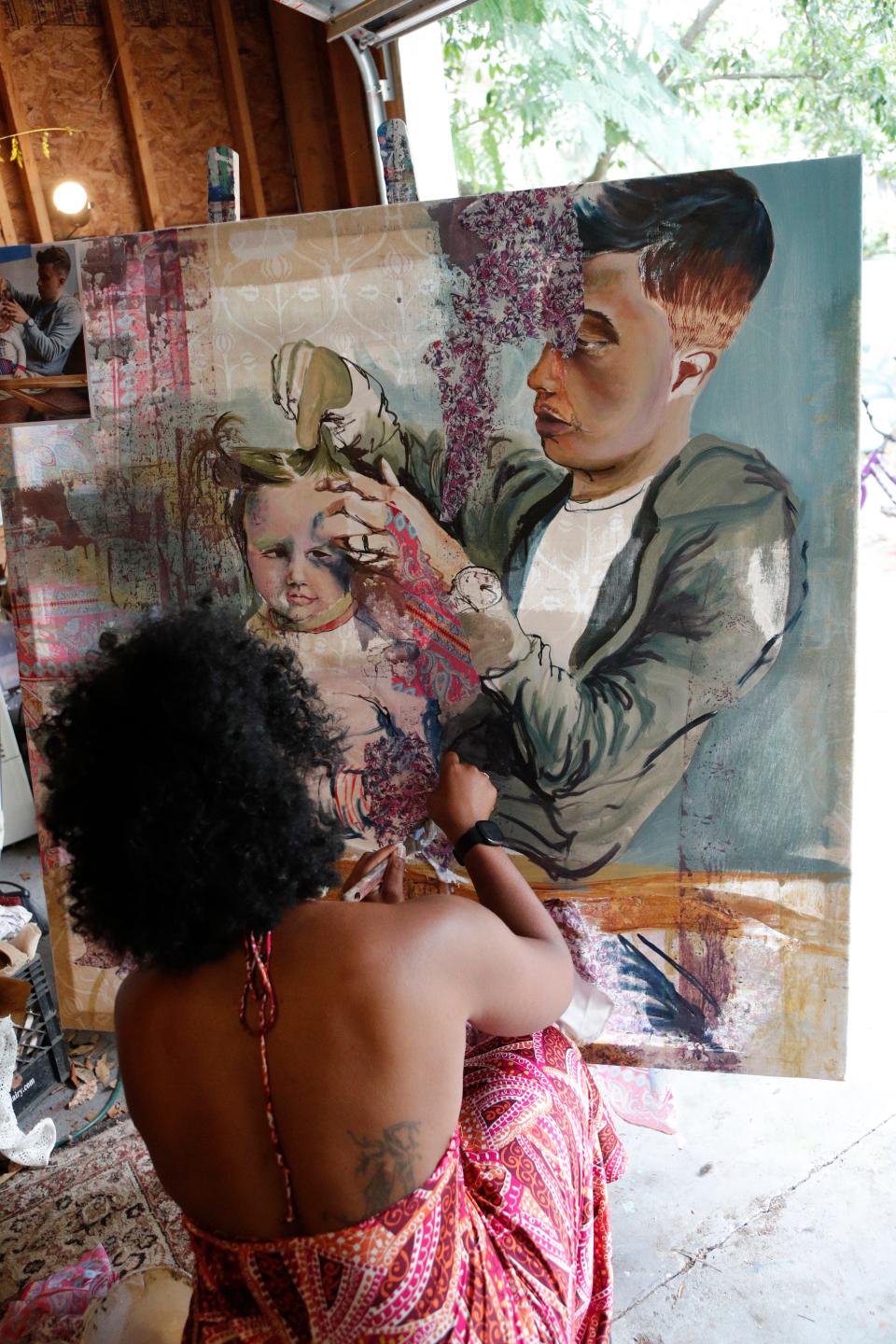 Artist Gabe Torres works in her studio.