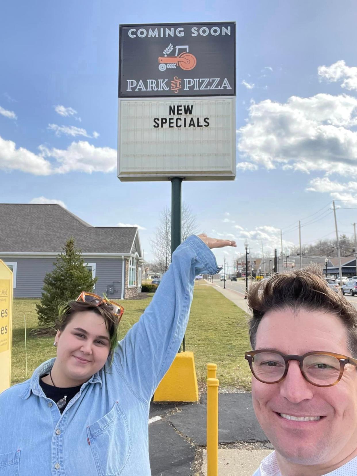 Jaynie Hazlett, general manager of the new North Canton location, and founder, Rocky Shanower, stand in front of the Park Street Pizza sign at 1212 S. Main St. The sign denoting new specials is from a previous business, as Park Street Pizza will offer a menu very similar to its original location.