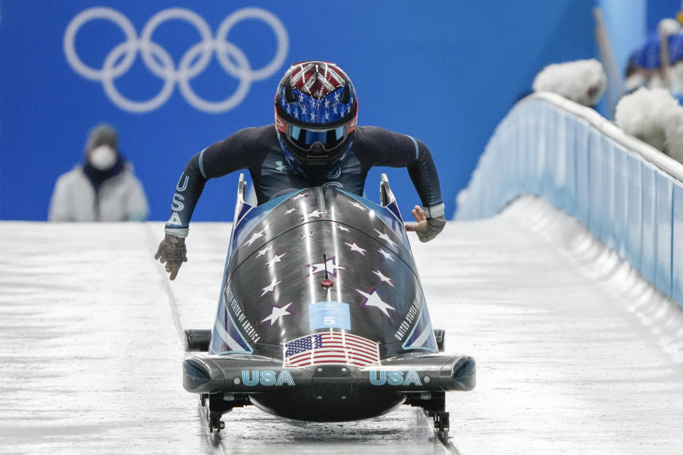 Kaillie Humphries, of the United States, drives during the women's monobob heat 3 at the 2022 Winter Olympics, Monday, Feb. 14, 2022, in the Yanqing district of Beijing. (AP Photo/Mark Schiefelbein)