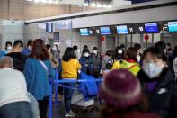 Passengers wearing masks are seen at the Pudong International Airport in Shanghai