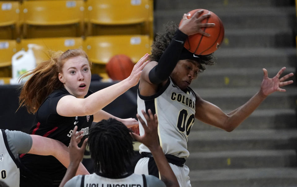 Colorado guard Jaylyn Sherrod, right, pulls in a rebound as Stanford forward Ashten Prechtel defends in the first half of an NCAA college basketball game Sunday, Jan. 17, 2021, in Boulder, Colo. (AP Photo/David Zalubowski)