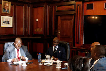 South Africa's new finance minister, Malusi Gigaba (2nd R) speaks with members of the treasury during his visit to their offices in Pretoria, South Africa, March 31,2017. REUTERS/Siphiwe Sibeko