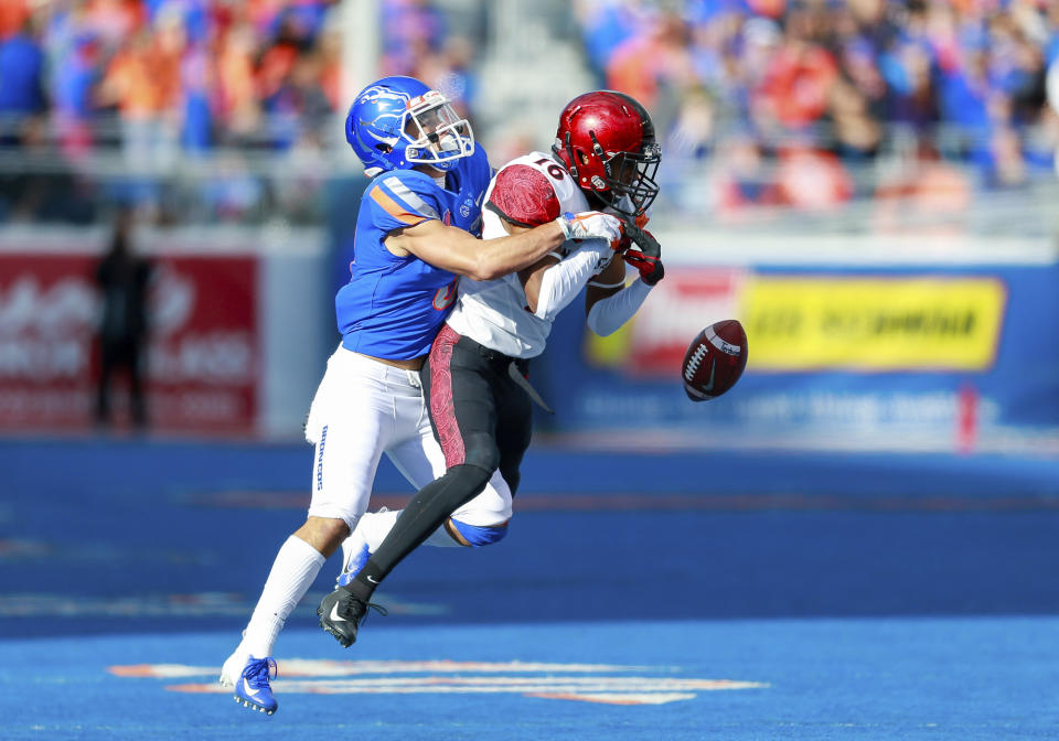 San Diego State cornerback Luq Barcoo, right, had the ball knocked out of his hands by Boise State wide receiver Sean Modster, left, to break up a possible interception in the second half of the NCAA college football game, Saturday, Oct. 6, 2018, in Boise, Idaho. San Diego State won 19-13.(AP Photo/Steve Conner)