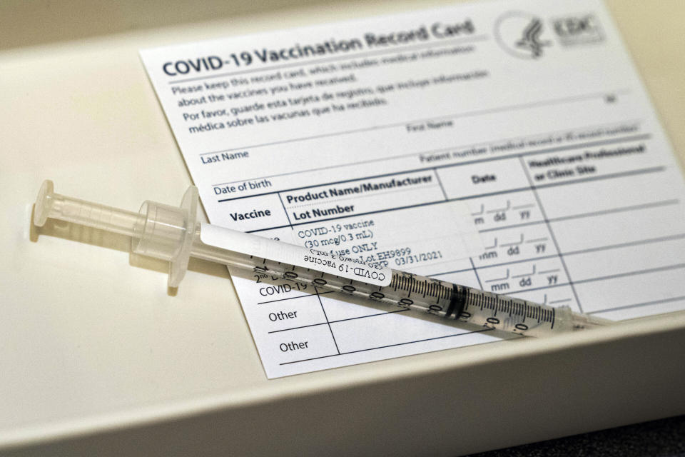 FILE - In this Wednesday, Dec. 16, 2020, file photo, a syringe containing a dose of the Pfizer COVID-19 vaccine sits in a container during a vaccine clinic at Providence Alaska Medical Center in Anchorage, Alaska. Overwhelmed by a surge in COVID-19 patients, Providence Alaska Medical Center, Alaska’s largest hospital, on Tuesday, Sept. 14, 2021, implemented crisis standards of care, prioritizing resources and treatments to those patients who have the potential to benefit the most.(Loren Holmes/Anchorage Daily News via AP, Pool, File)