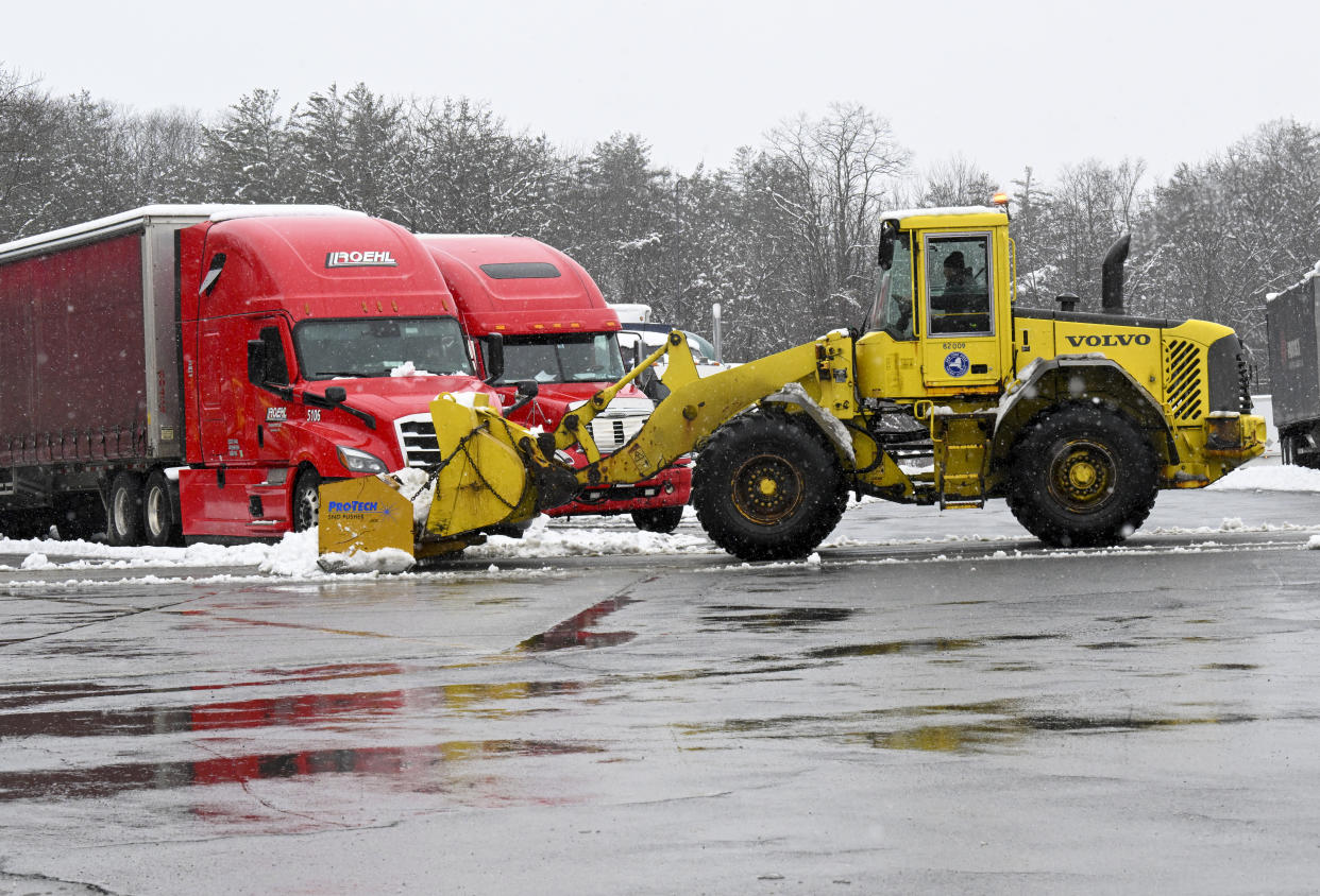 Crews remove snow from the Guilderland rest stop during a winter snow storm Tuesday, March 14, 2023, in Albany, N.Y. (AP Photo/Hans Pennink)