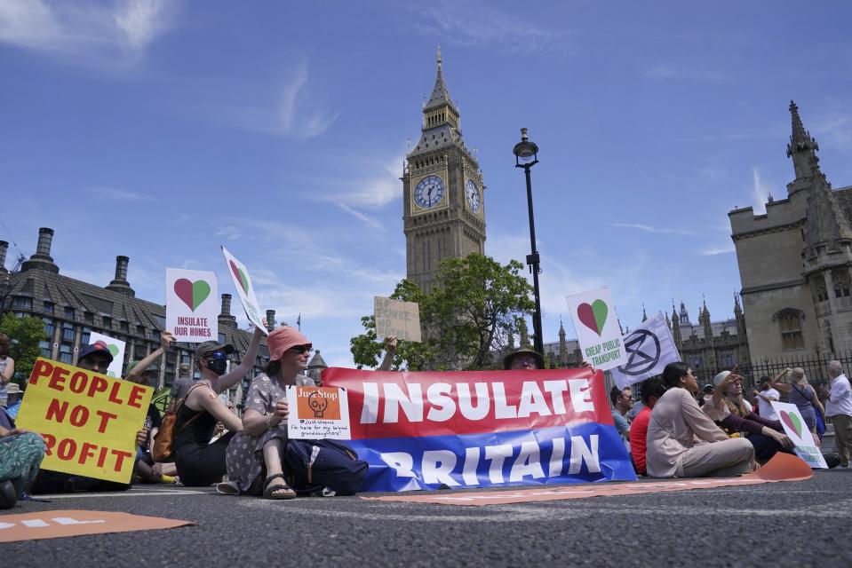 Members of environmental groups including Just Stop Oil, the Peace and Justice Project and Insulate Britain take part in a mass protest in Parliament Square, London. (Jonathan Brady/PA via AP)