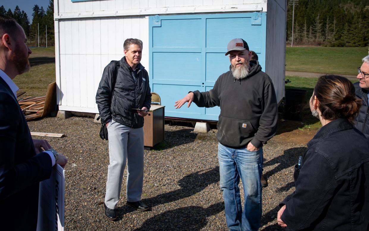 Crow High School building instructor Kyle Kishen, right, discusses the "Shed-ucation" program.