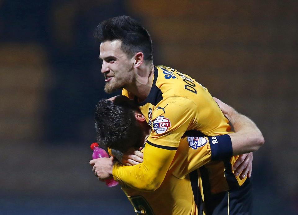 Cambridge United's Ryan Donaldson (top) celebrates with Tom Champion at the final whistle of their English FA Cup 4th round soccer match against Manchester United at The Abbey Stadium in Cambridge, eastern England January 23, 2015. REUTERS/Andrew Winning (BRITAIN - Tags: SPORT SOCCER)