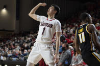 Davidson guard Hyunjung Lee (1) watches his 3-point shot go in while guarded by Virginia Commonwealth guard KeShawn Curry (11) during the first half of an NCAA college basketball game in Davidson, N.C., Wednesday, Jan. 26, 2022. (AP Photo/Jacob Kupferman)