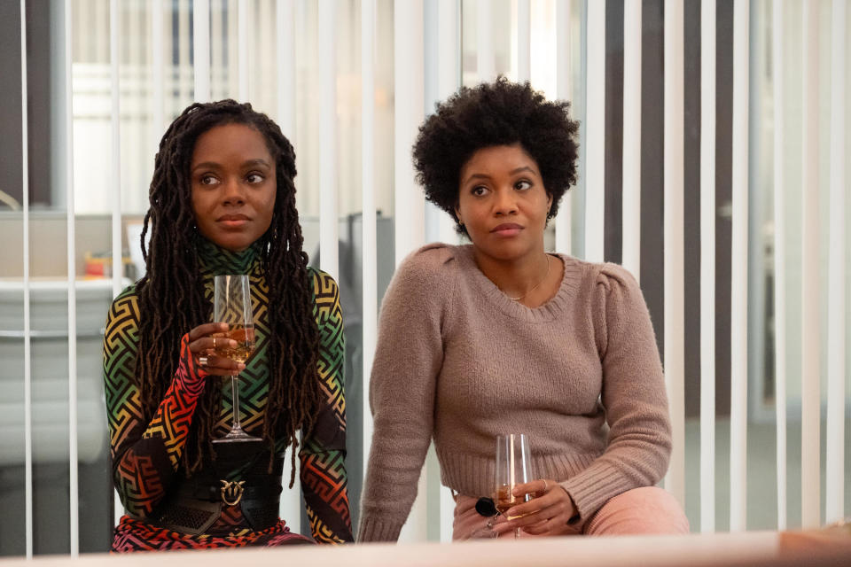 Two women sip champagne in an office conference room; still from "The Other Black Girl"