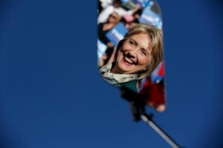 Democratic presidential candidate Hillary Clinton is reflected in a glass teleprompter as she holds a rally with grassroots supporters in Alexandria, Virginia, October 23, 2015. REUTERS/Jonathan Ernst