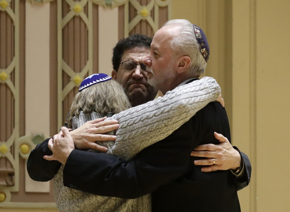 FILE - In this Oct. 28, 2018, file photo, Rabbi Jeffrey Myers, right, of Tree of Life/Or L'Simcha Congregation hugs Rabbi Cheryl Klein, left, of Dor Hadash Congregation and Rabbi Jonathan Perlman during a community gathering held in the aftermath of a deadly shooting at the Tree of Life Synagogue in Pittsburgh. The machete attack on a rabbi's home in Monsey, New York, during Hanukkah and the shooting of worshippers at a Texas church are refocusing attention on how vulnerable worshippers are during religious services. FBI hate crime statistics show there is reason for concern. (AP Photo/Matt Rourke, File)