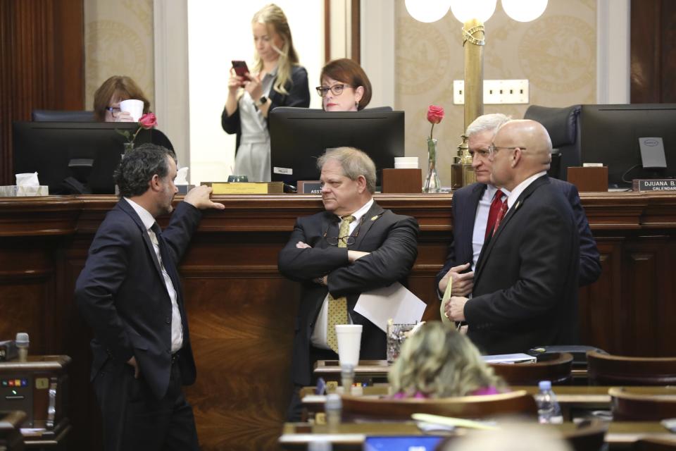 From left to right, South Carolina Rep. Bruce Bannister, R-Greenville, Rep. Weston Newton, R-Bluffton, Rep. Jason Elliott, R-Greenville, and Rep. Mark Smith, R-Daniel Island, talk as the House debates a bill to allow Sunday liquor sales on Wednesday, Feb. 14, 2024, in Columbia, S.C. (AP Photo/Jeffrey Collins)