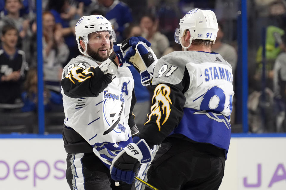 Tampa Bay Lightning right wing Nikita Kucherov (86) celebrates his goal against the Calgary Flames with center Steven Stamkos (91) during the second period of an NHL hockey game Thursday, Nov. 17, 2022, in Tampa, Fla. (AP Photo/Chris O'Meara)