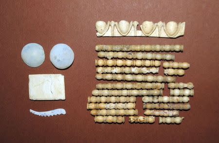 A handout photo shows decoration artefacts of glass and bone which were unearthed from a grave inside the site of an archaelogical excavation at the town of Amphipolis, in northern Greece, November 12, 2014. REUTERS/Hellenic Culture Ministry/Handout via Reuters