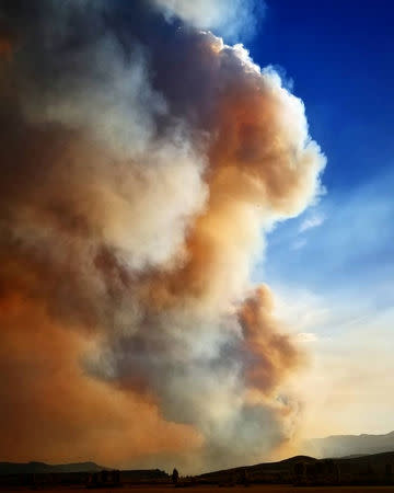 Smoke rises from a wildfire as seen from Bondurant, Wyoming, United States in this September 22, 2018 photo by Jared Kail. Jared Kail/Social Media/via REUTERS