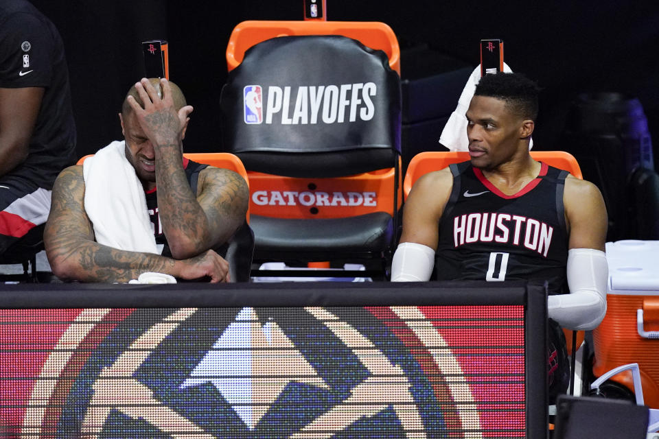 Houston Rockets' P.J. Tucker, left, and Russell Westbrook sit on the bench in the closing minutes of a loss to the Los Angeles Lakers. (AP Photo/Mark J. Terrill)