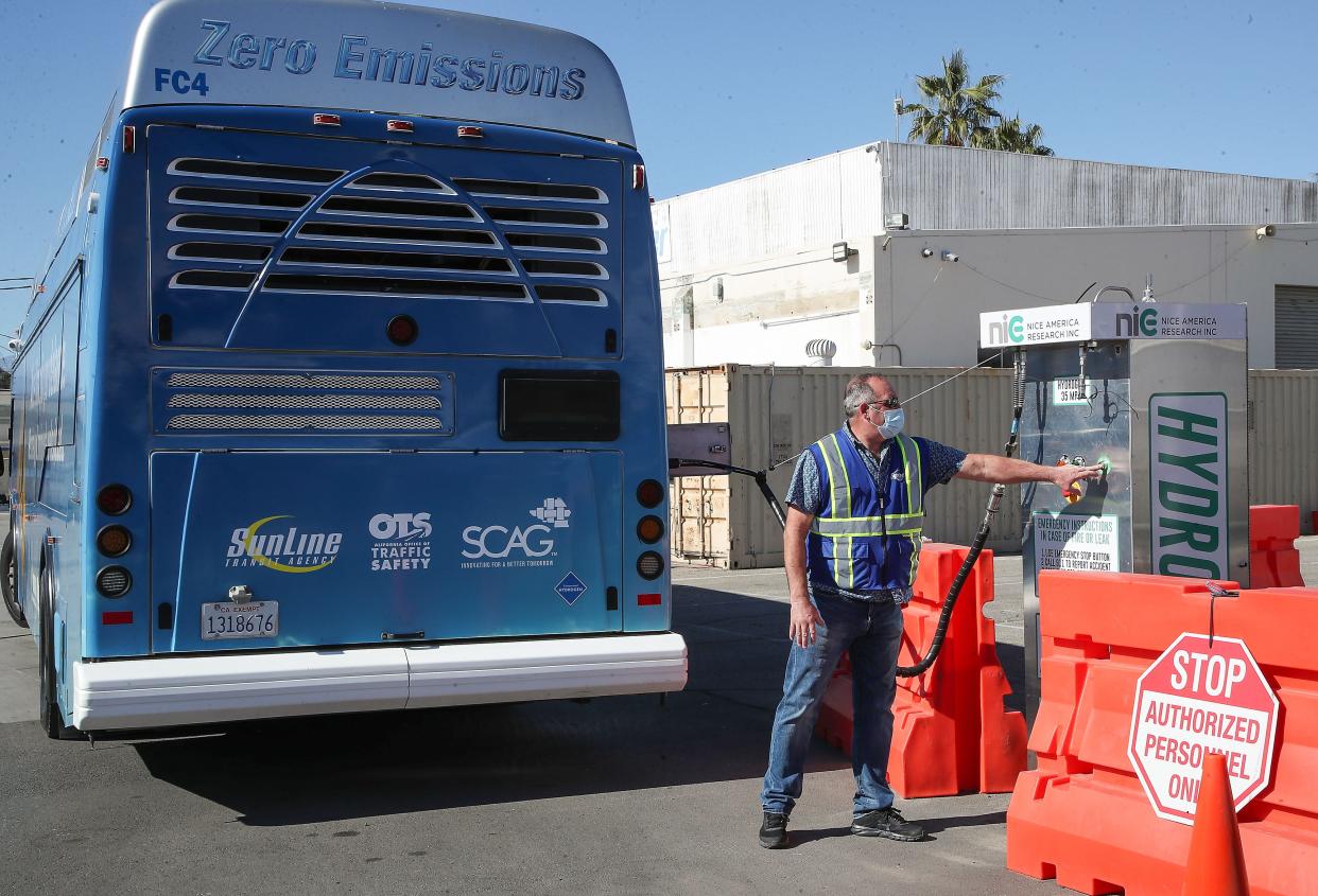 Frank Rytych of Sunline fuels a hydrogen powered bus during a demonstration of Sunline's submerged liquid hydrogen pump in Indio, Calif., Wednesday, January 19, 2022.