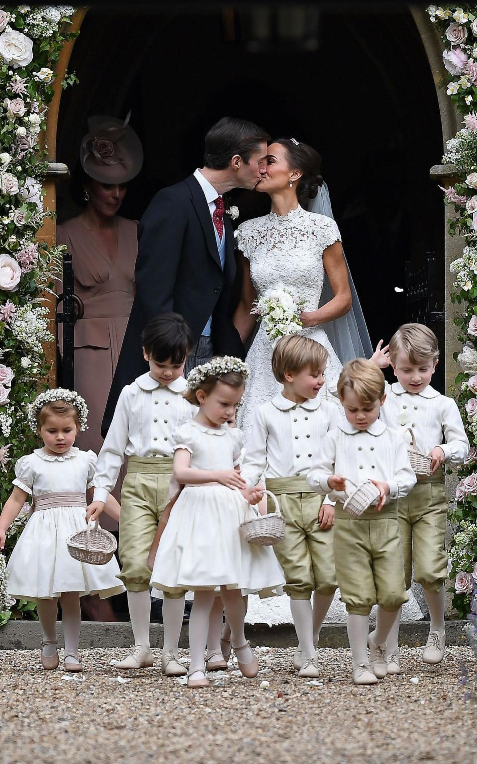 Pippa and James leave the church, flanked by their bridesmaids ad pageboys - Credit: AFP