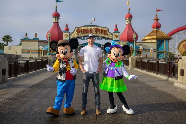 A very serious Evans poses with Mickey Mouse and Minnie Mouse on Saturday. (Photo: Handout via Getty Images)