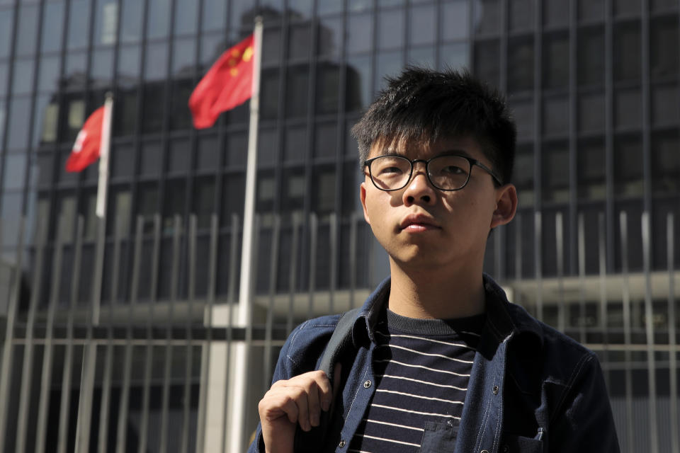 Pro-democracy activist Joshua Wong stands outside the Legislative Council building in Hong Kong, Thursday, Nov. 28, 2019. Police teams on Thursday began clearing a Hong Kong university that was a flashpoint for clashes with anti-government demonstrators, as the government slammed a U.S. move to sign into law bills supporting human rights in the Chinese territory. (AP Photo/Kin Cheung)