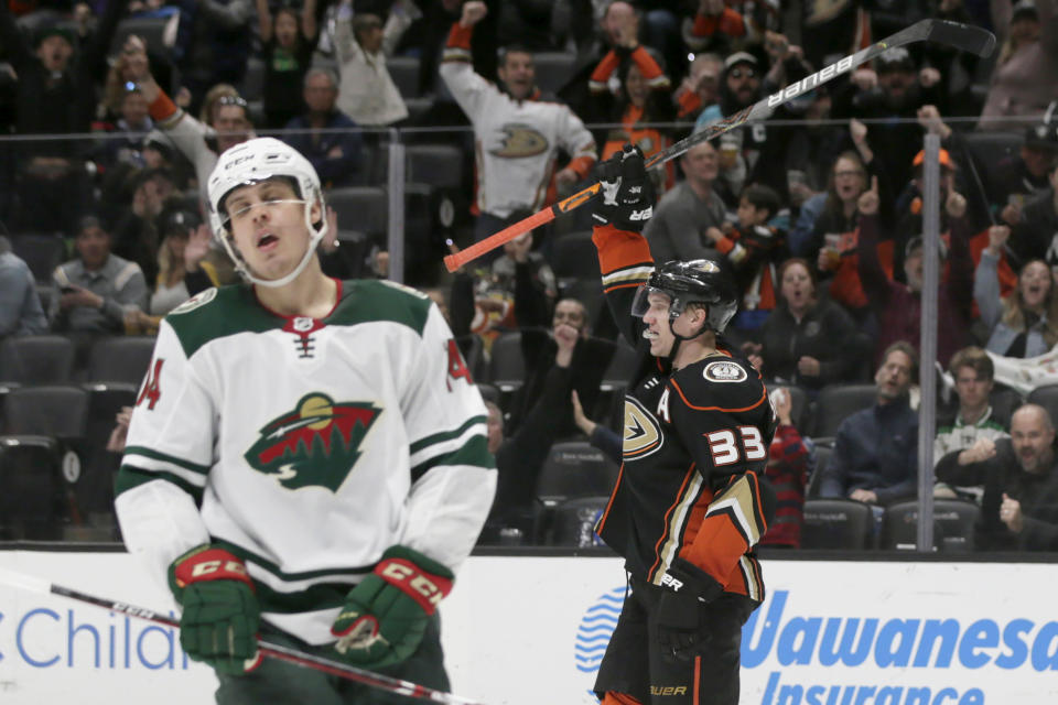 Anaheim Ducks right wing Jakob Silfverberg, right, of Sweden, raises his stick in celebration, after scoring a goal, as Minnesota Wild center Joel Eriksson Ek, left, of Sweden, laments during the second period of an NHL hockey game in Anaheim, Calif., Sunday, March 8, 2020. (AP Photo/Alex Gallardo)