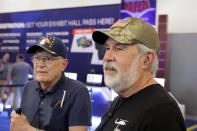Convention attendees Bill Galis, left, and Gary Francis, right, talks about their views of the current state of the NRA and the Uvalde school shooting, at the NRA Annual Meeting held at the George R. Brown Convention Center Thursday, May 26, 2022, in Houston. (AP Photo/Michael Wyke)